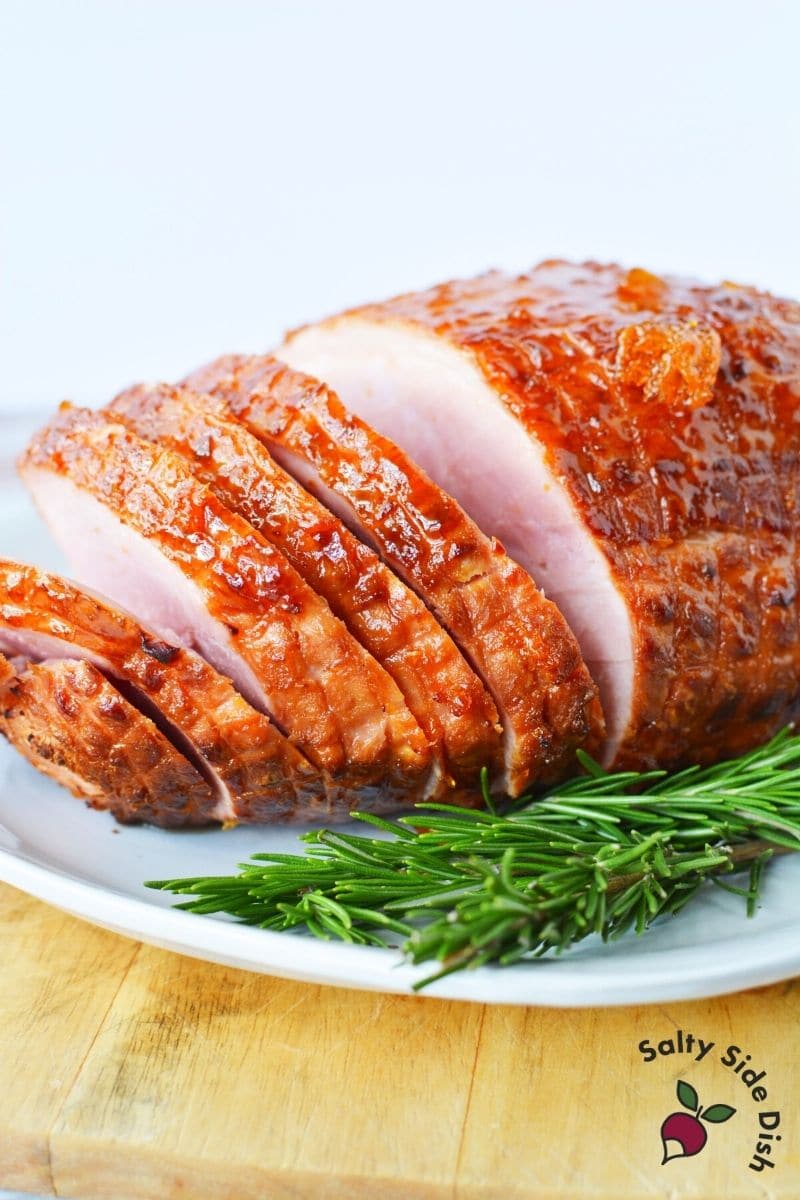 Ninja Foodi Ham for Thanksgiving ready to serve with rosemary on the side