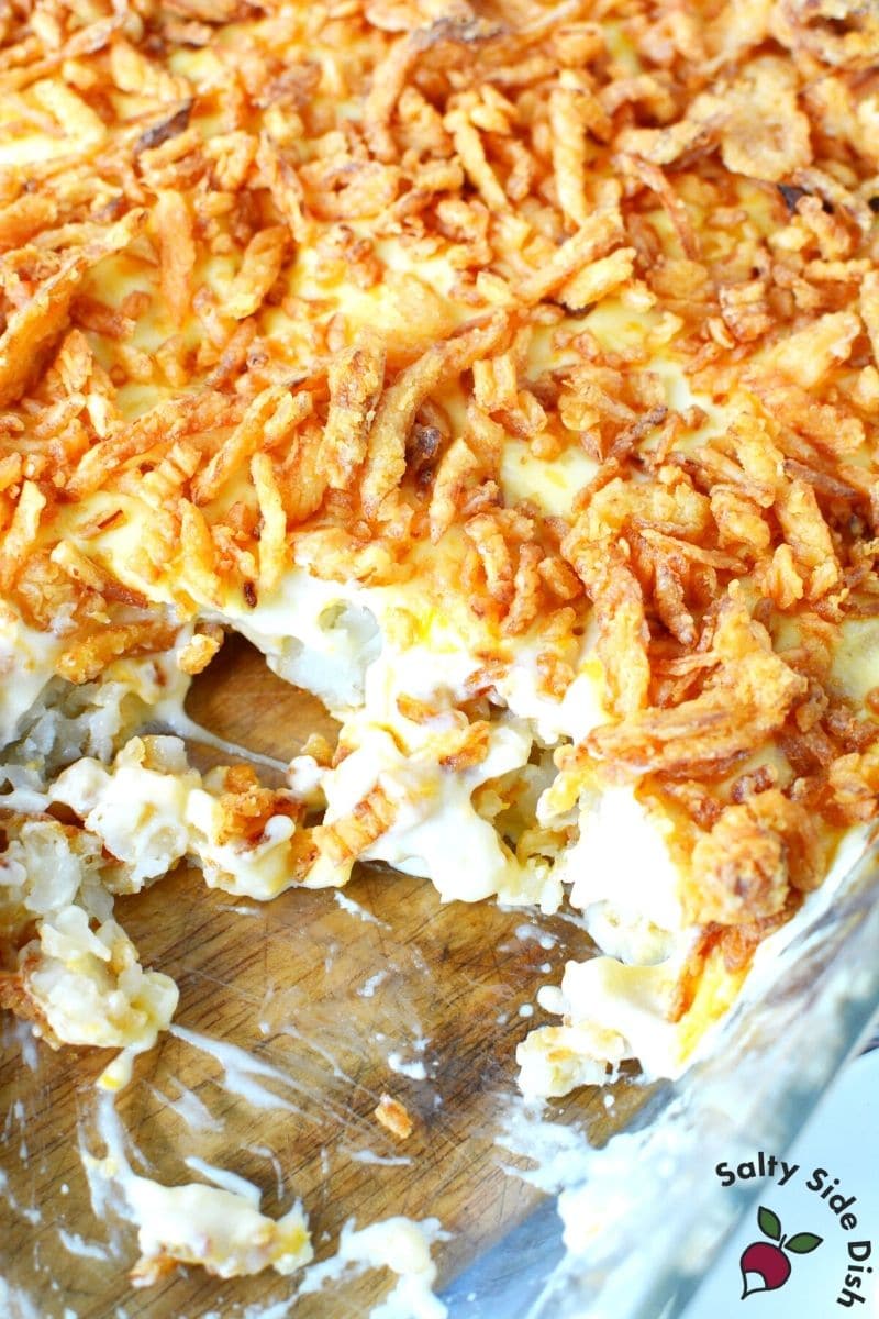 scoopable tater tater tot casserole is so creamy, this one shows a huge scoop out of the dish