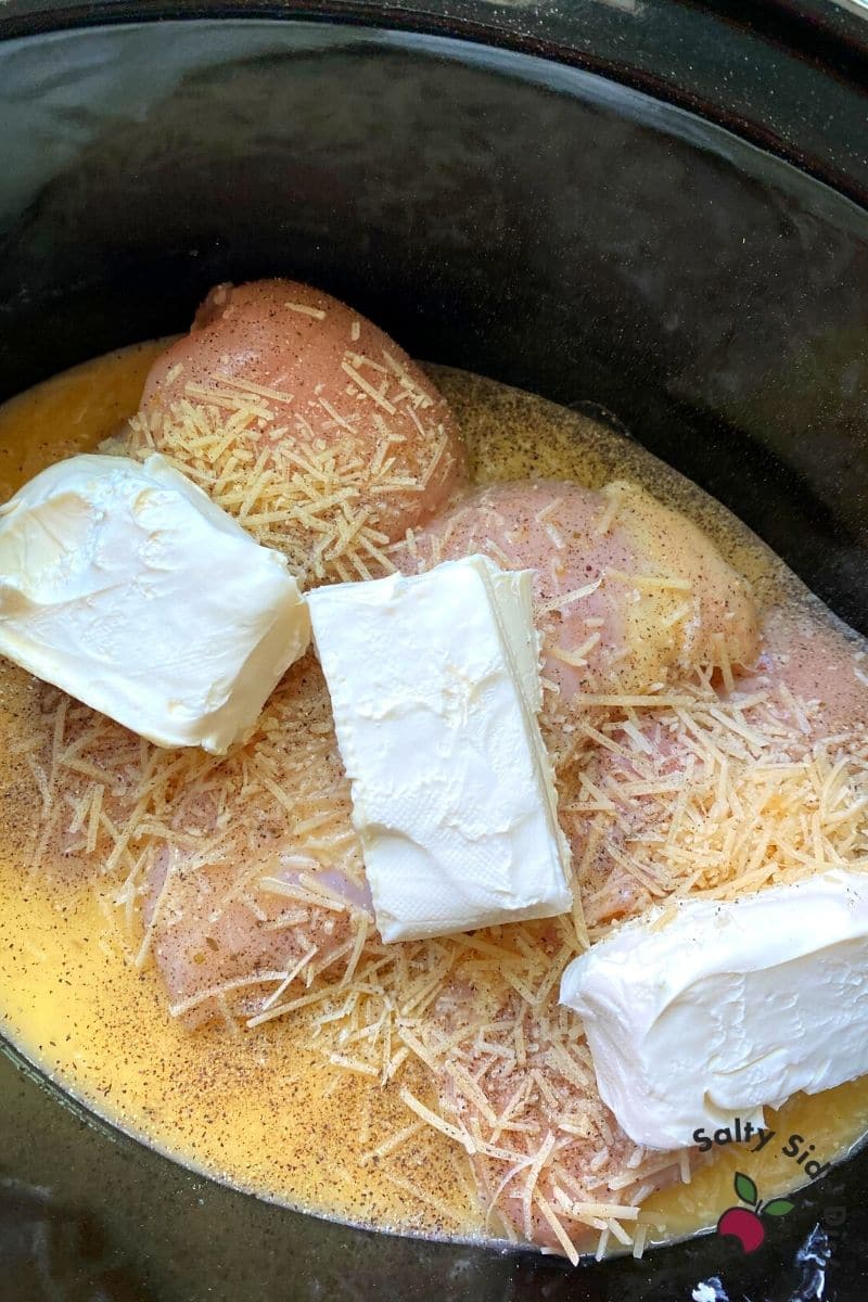 cream cheese inside of slow cooker with chicken
