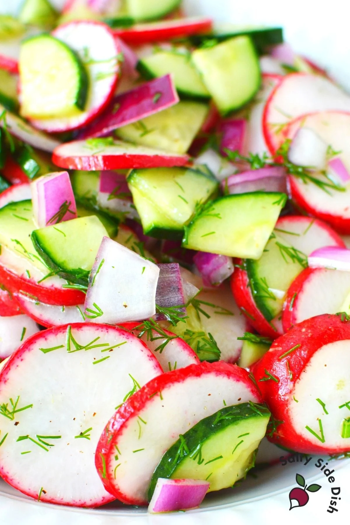 slices of radishes and quartered cucumbers in a bowl.