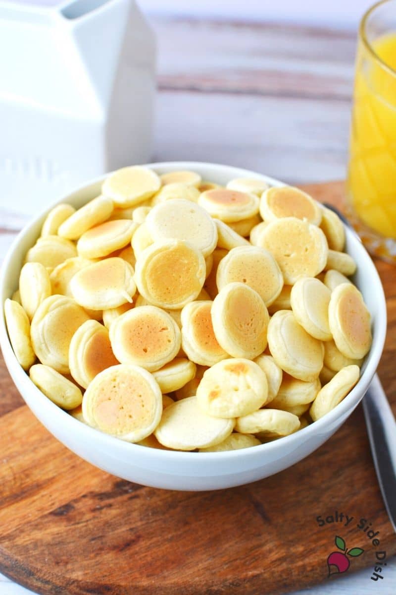 miniature pancakes (just like full size but tiny) in a bowl ready to serve with milk