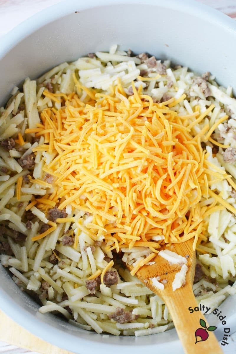 Add frozen hash browns to pot with the cooked sausage and mix well. Add cheese