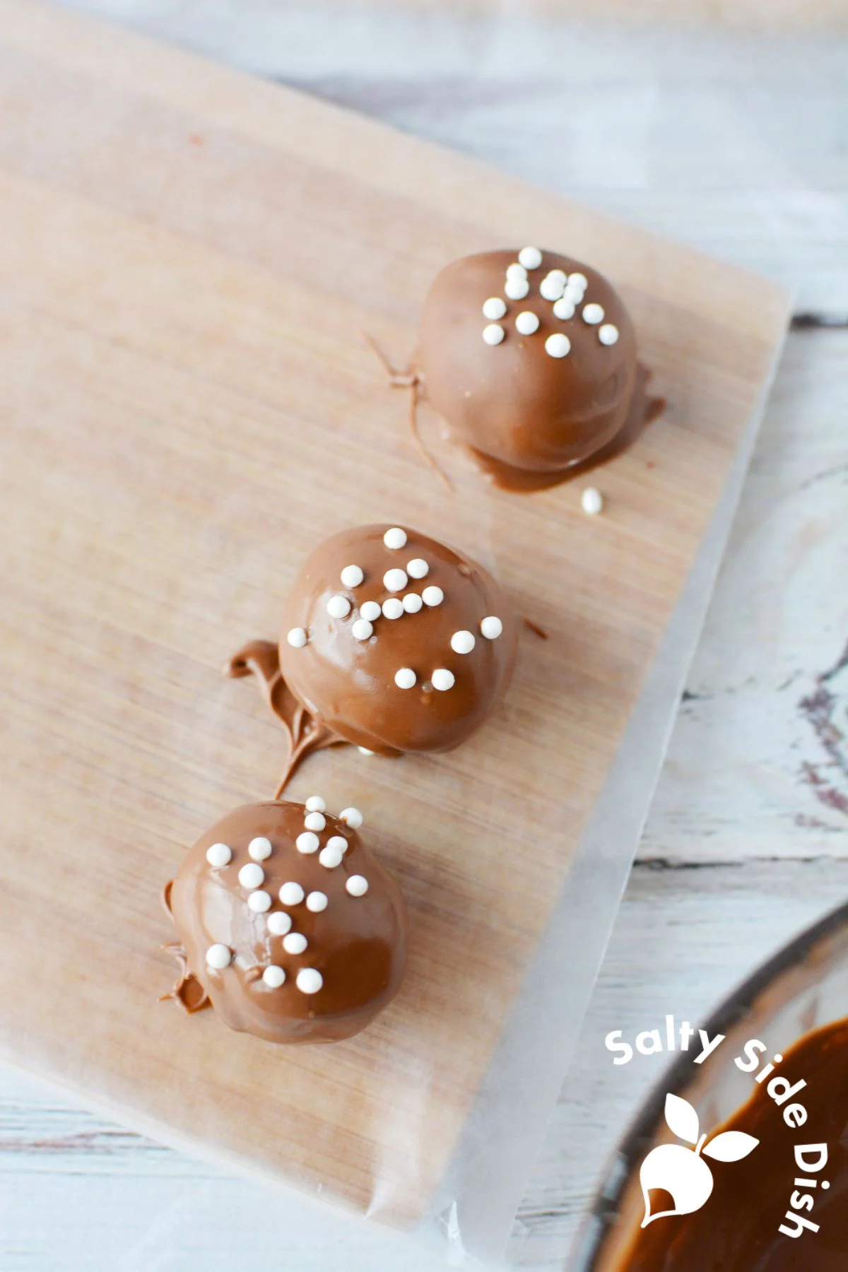chocolate dipped cake balls on a platter.