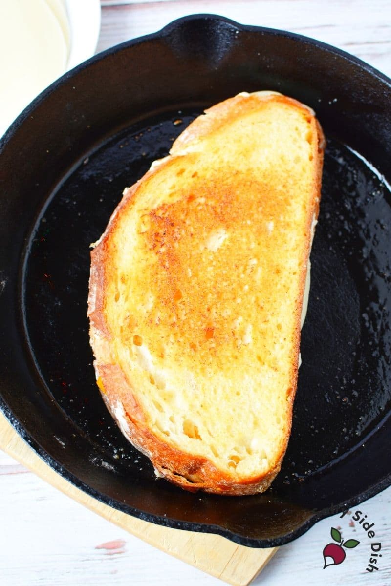 golden brown grilled cheese in the cast iron pan