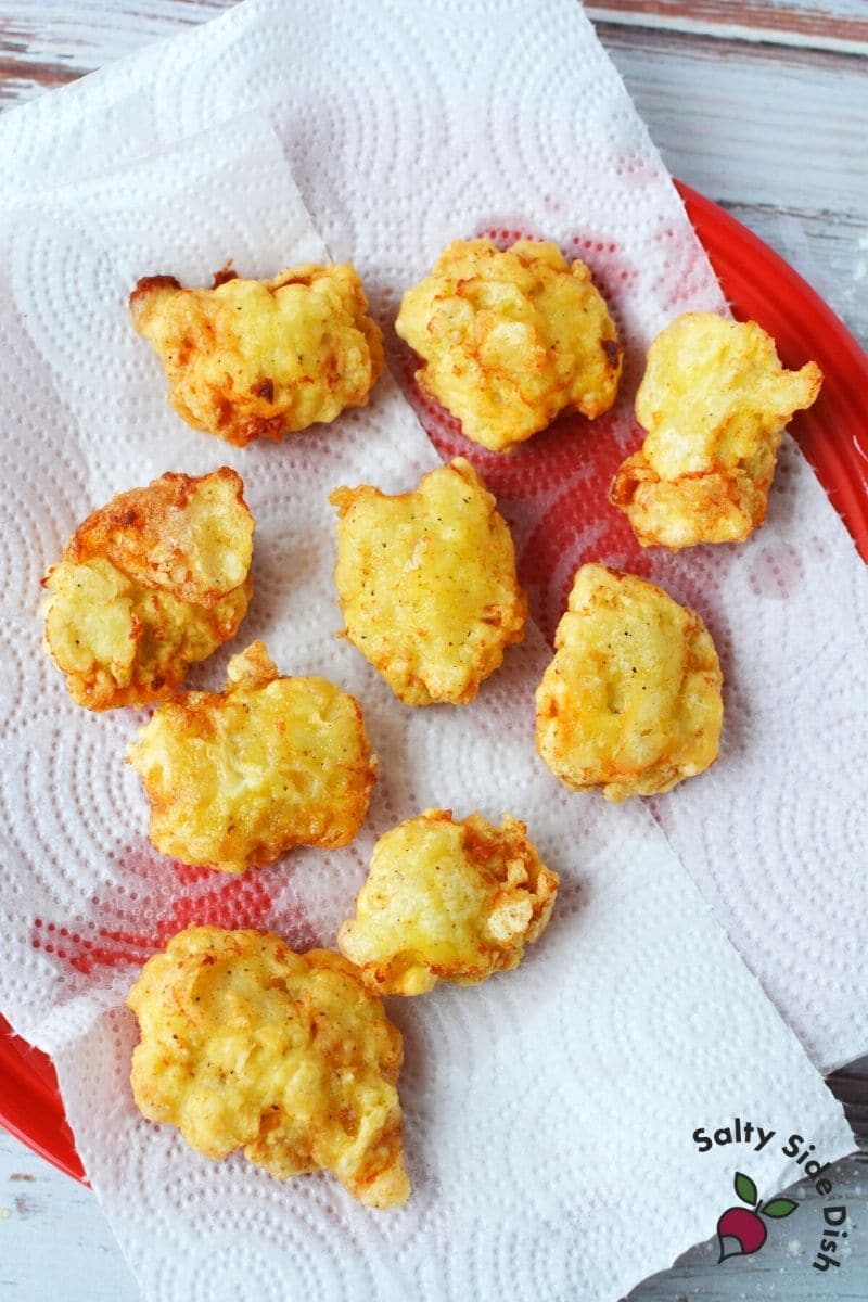 fry chicken nuggets in oil and drain on a paper towel