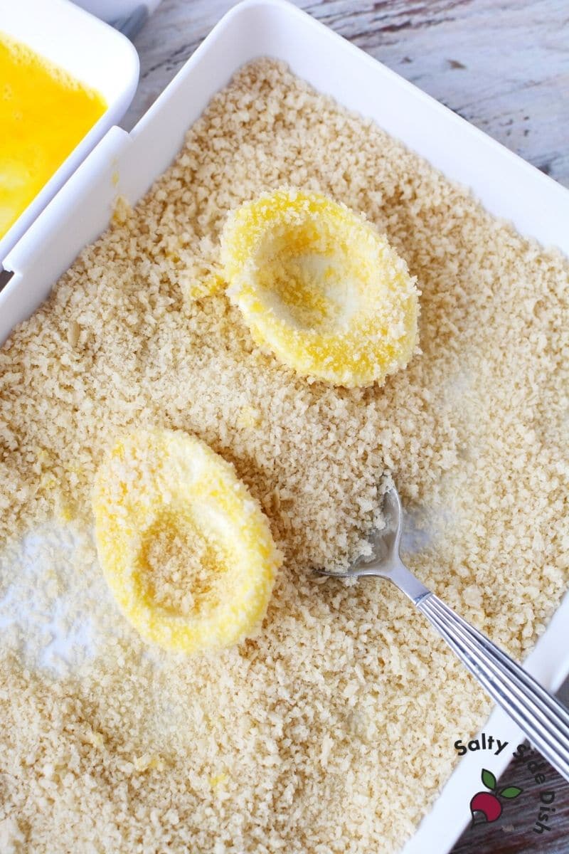 smother boiled egg white with bread crumbs