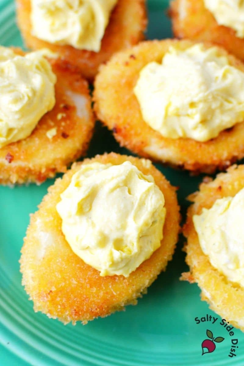 Fried Deviled Eggs sitting on a plate and already fried