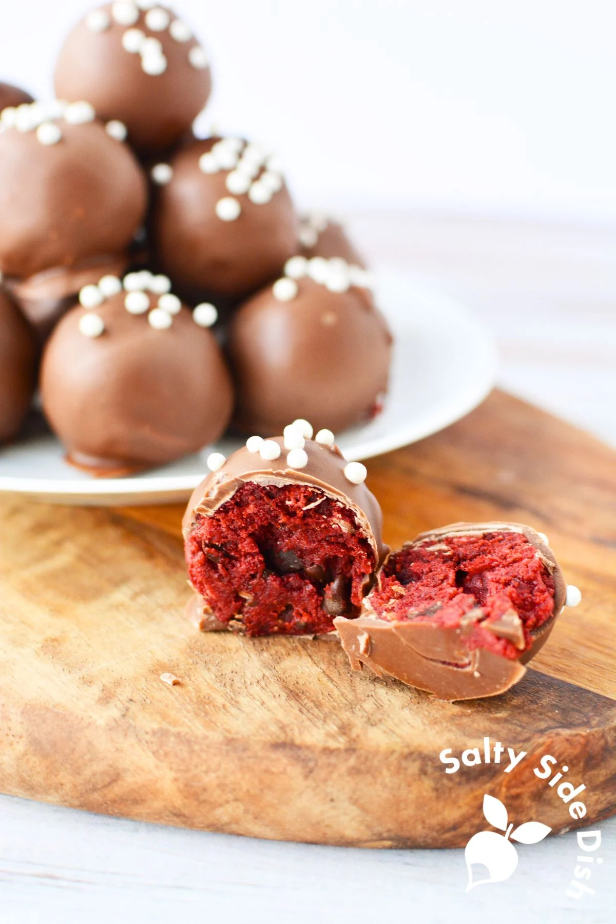 red velvet cake made into a cream cheese truffle smothered in chocolate.