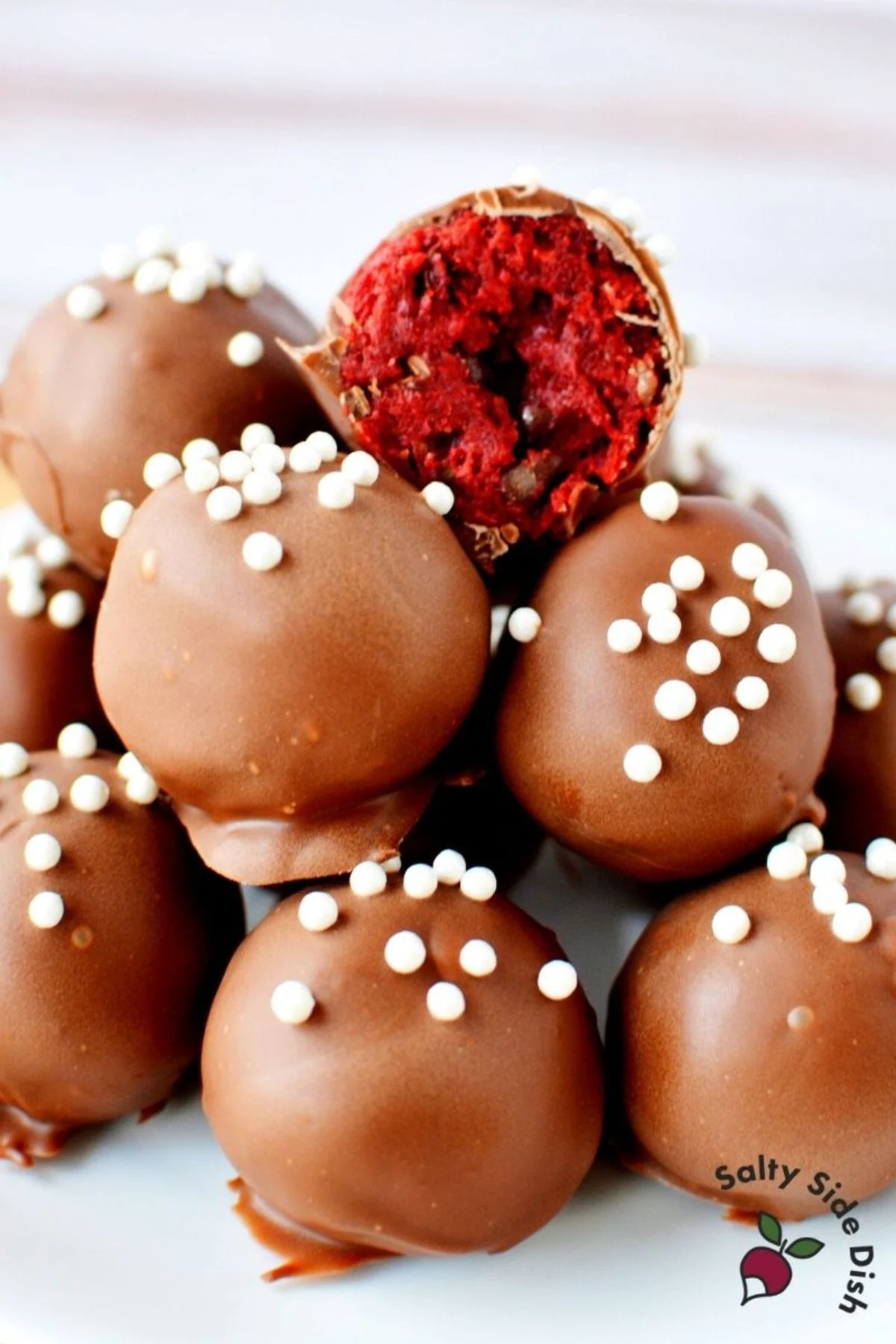 homemade red velvet cake balls with chocolate ready to serve.