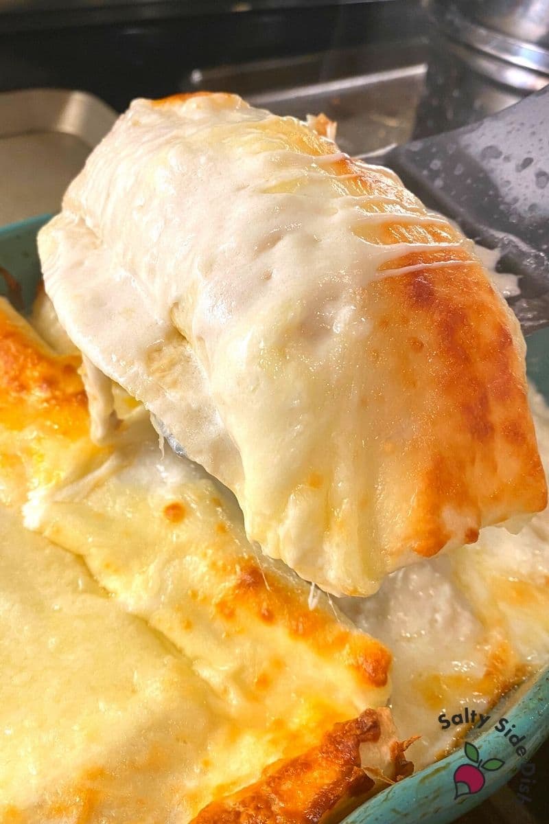 pulling enchilada out of the pan.