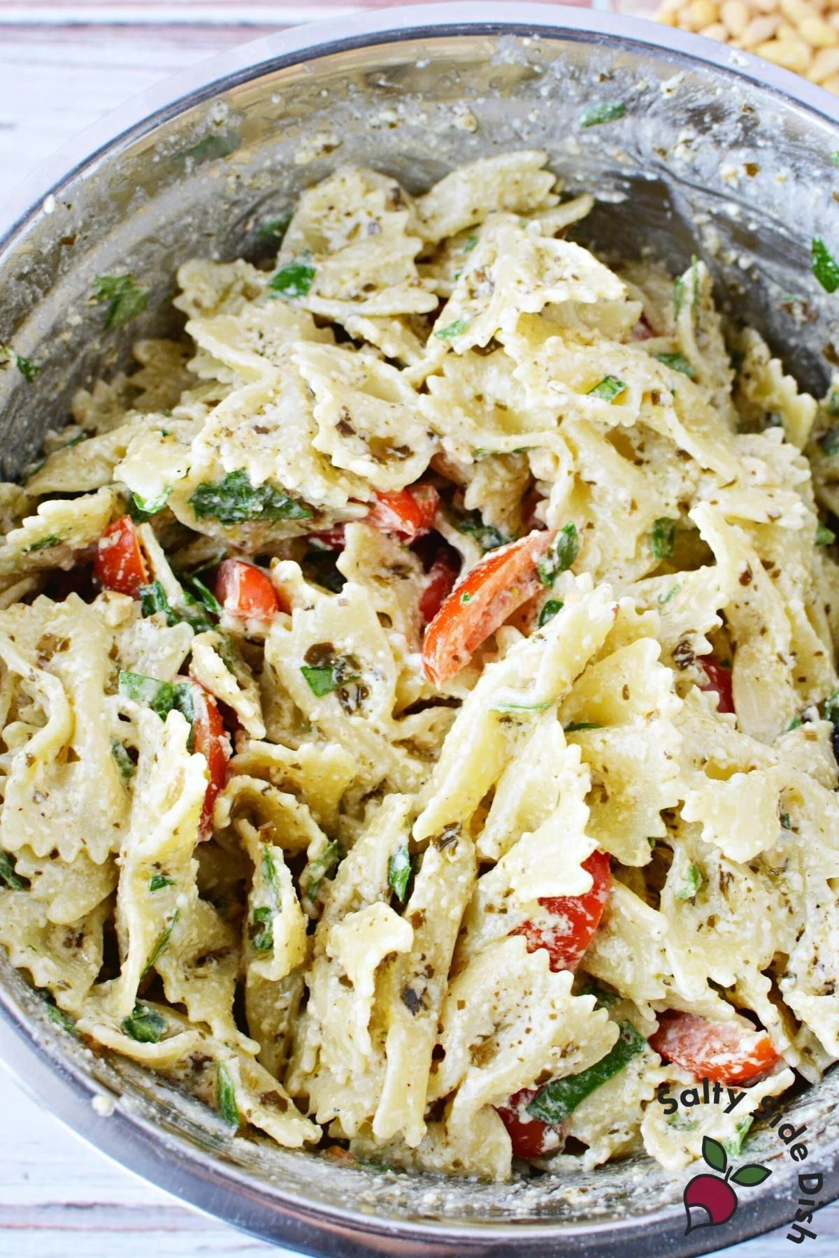 cold bowtie pasta salad in a mixing bowl.