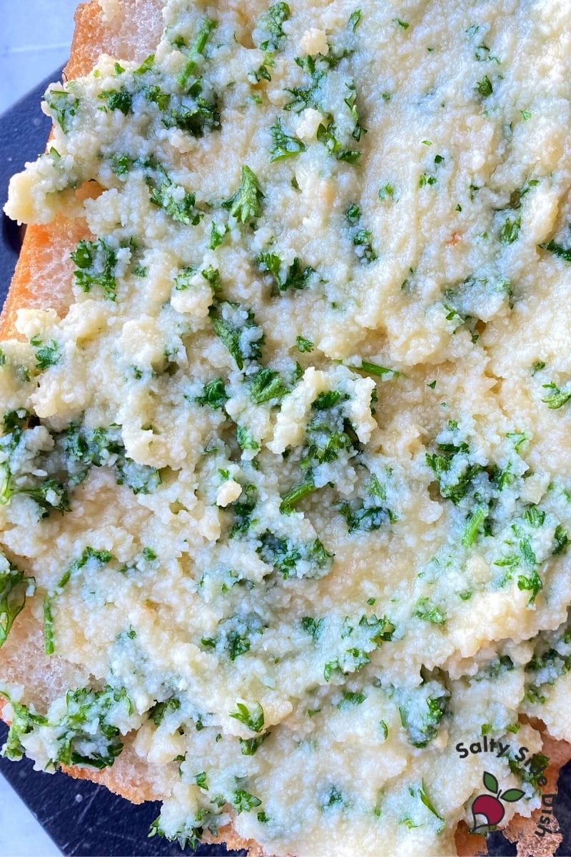 smother parmesan cheese mixture onto bread