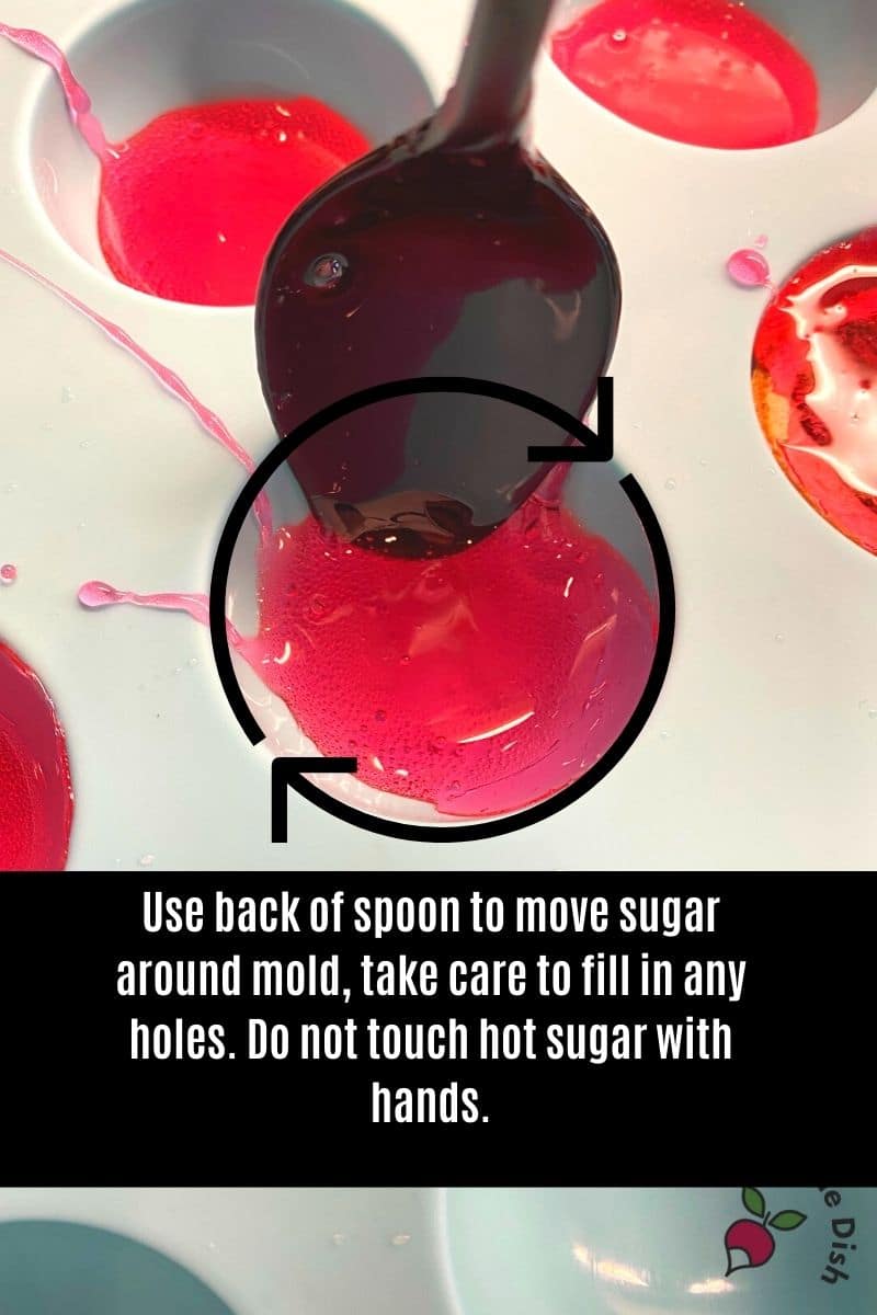 use back of spoon to quickly spread sugar candy in mold
