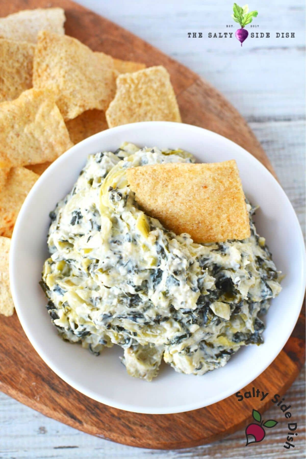 bowl of spinach and artichoke dip with pita bread
