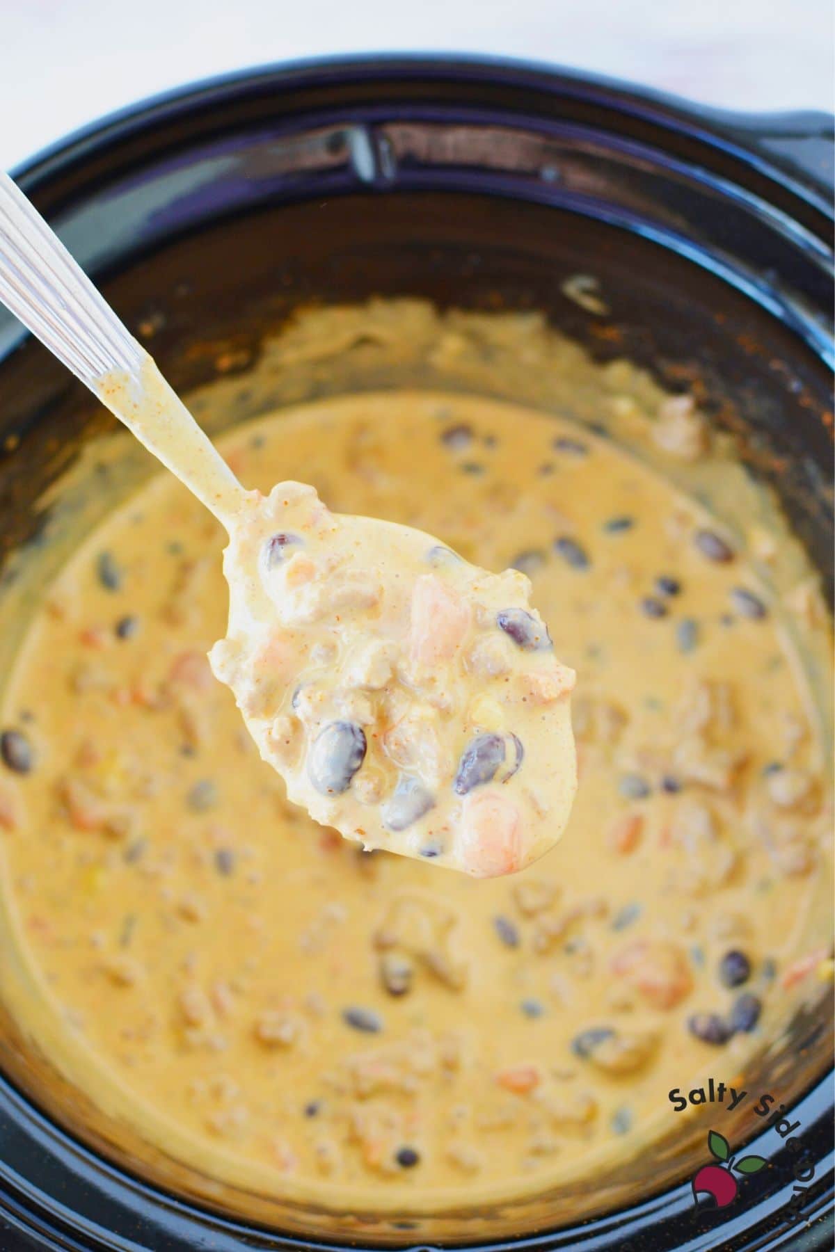 cheeseburger queso dip on a spoon