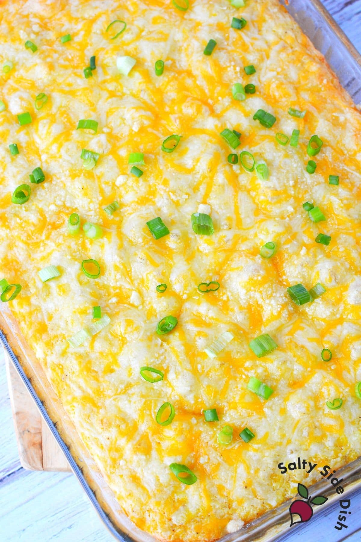 corn casserole in a dish all cheesy and baked