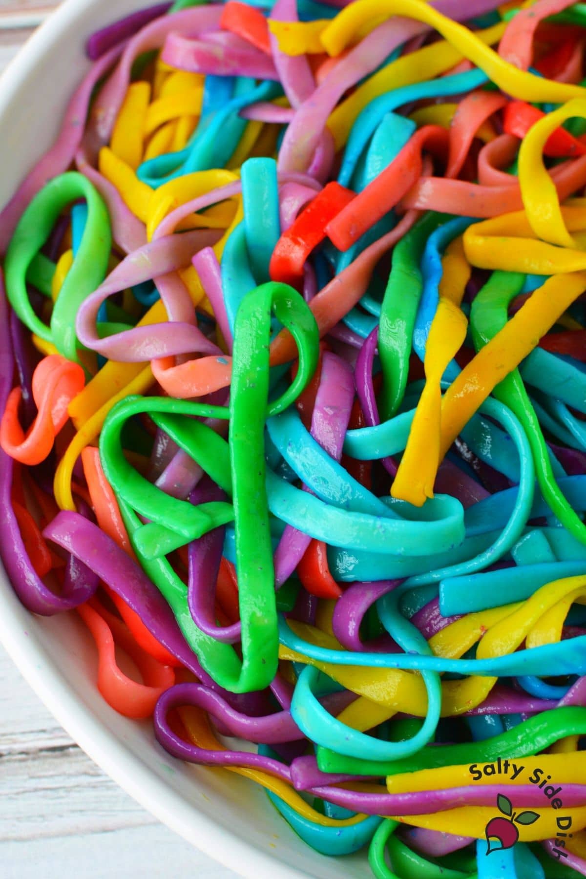 mixed up rainbow pasta in a bowl