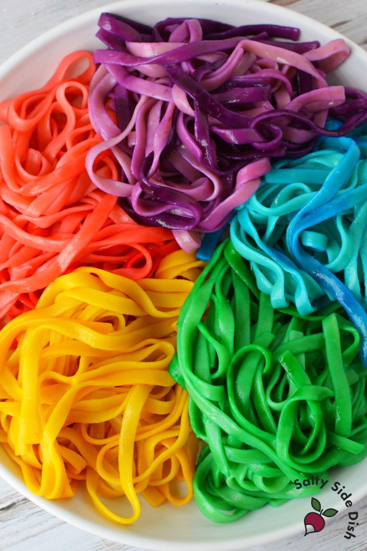 5 dyed pasta colors laying on a plate