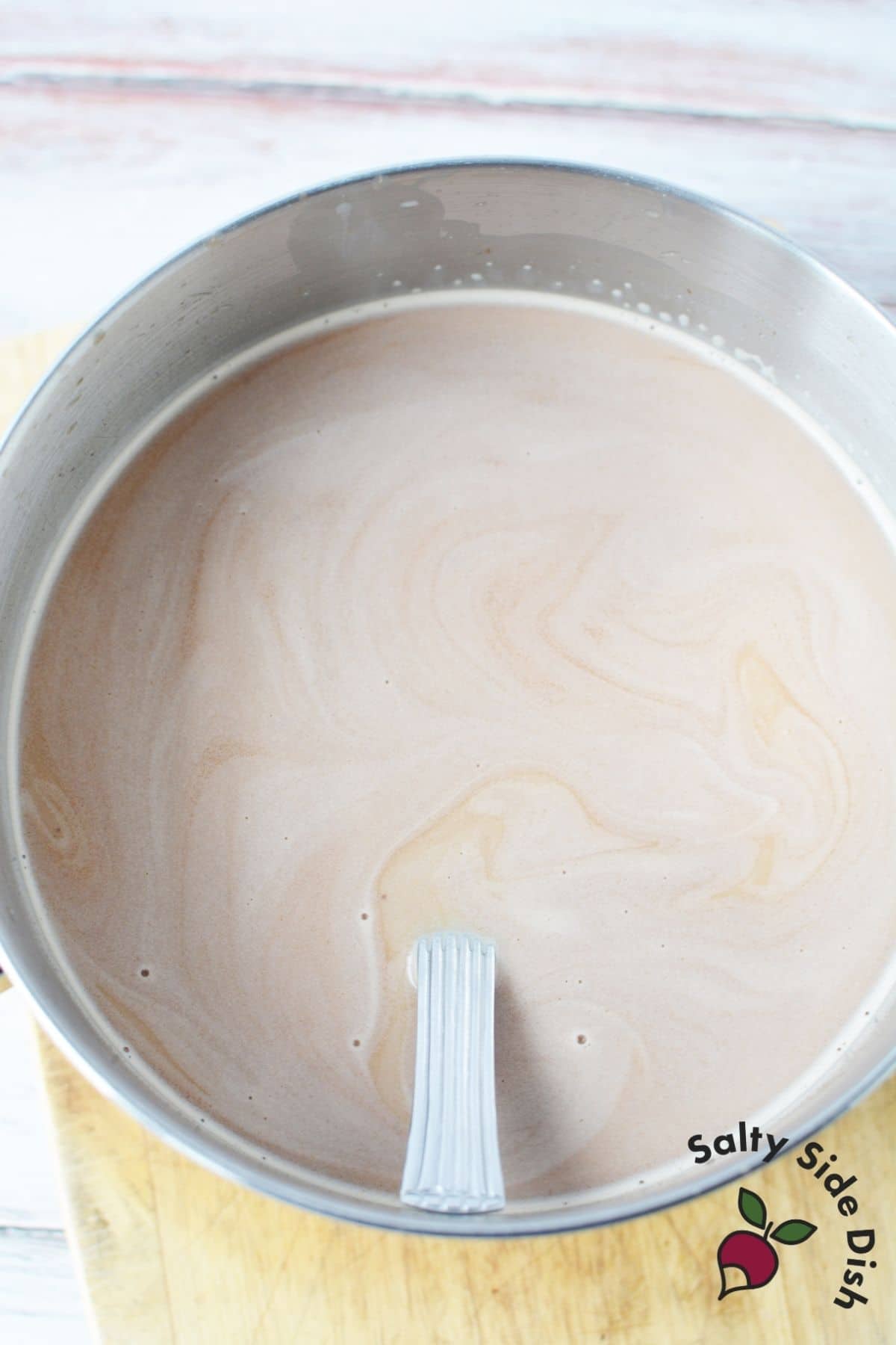 hot chocolate in a sauce pan with a spoon