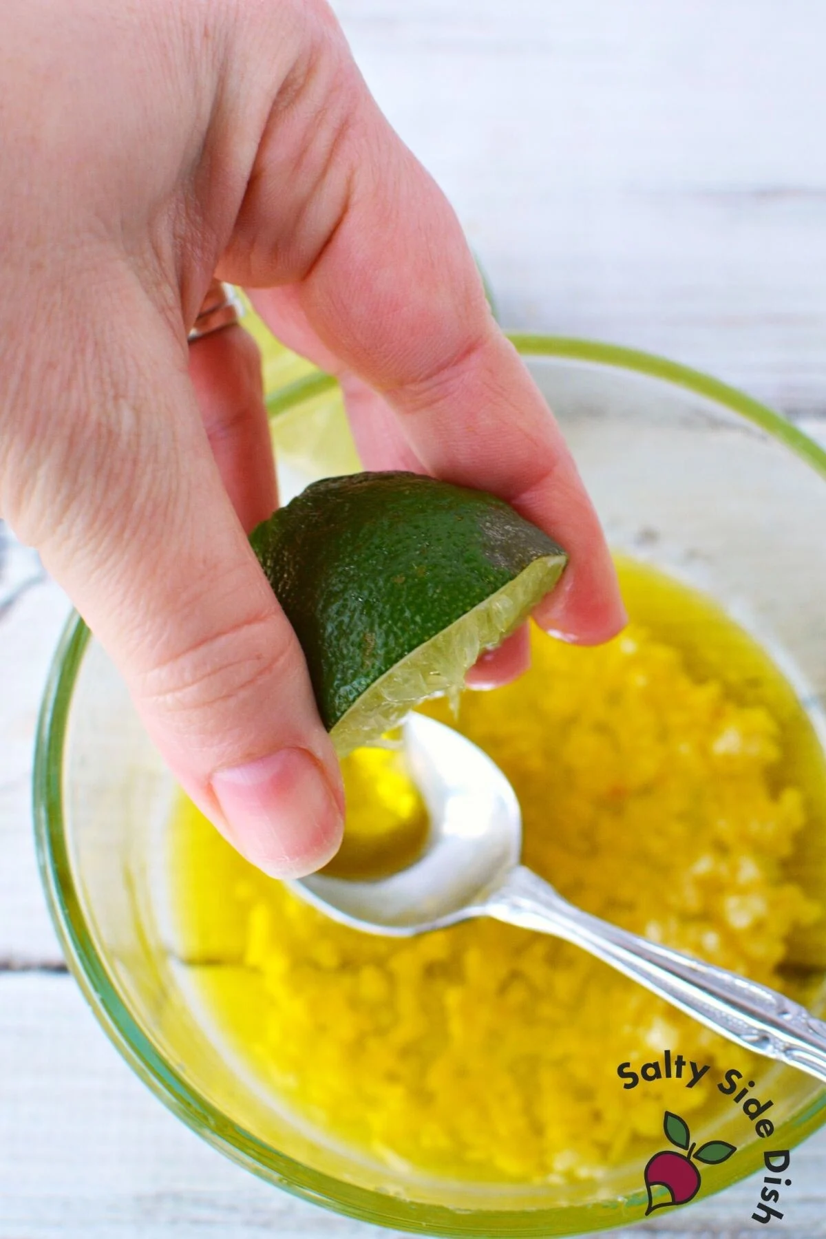 squeezing fresh lime juice into salsa.