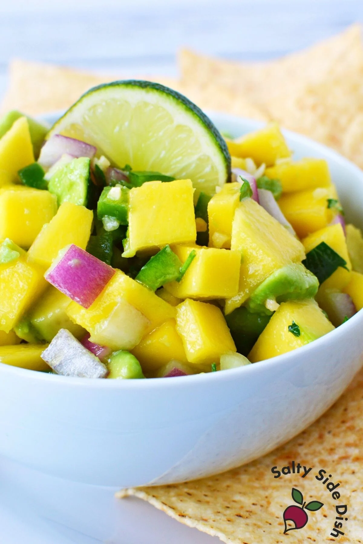 chunky fresh summer salsa in a white bowl.