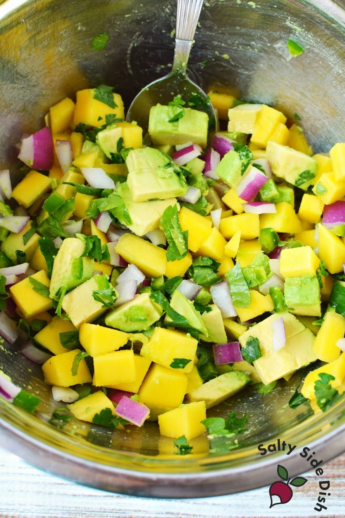 prepping fish salsa into a bowl.