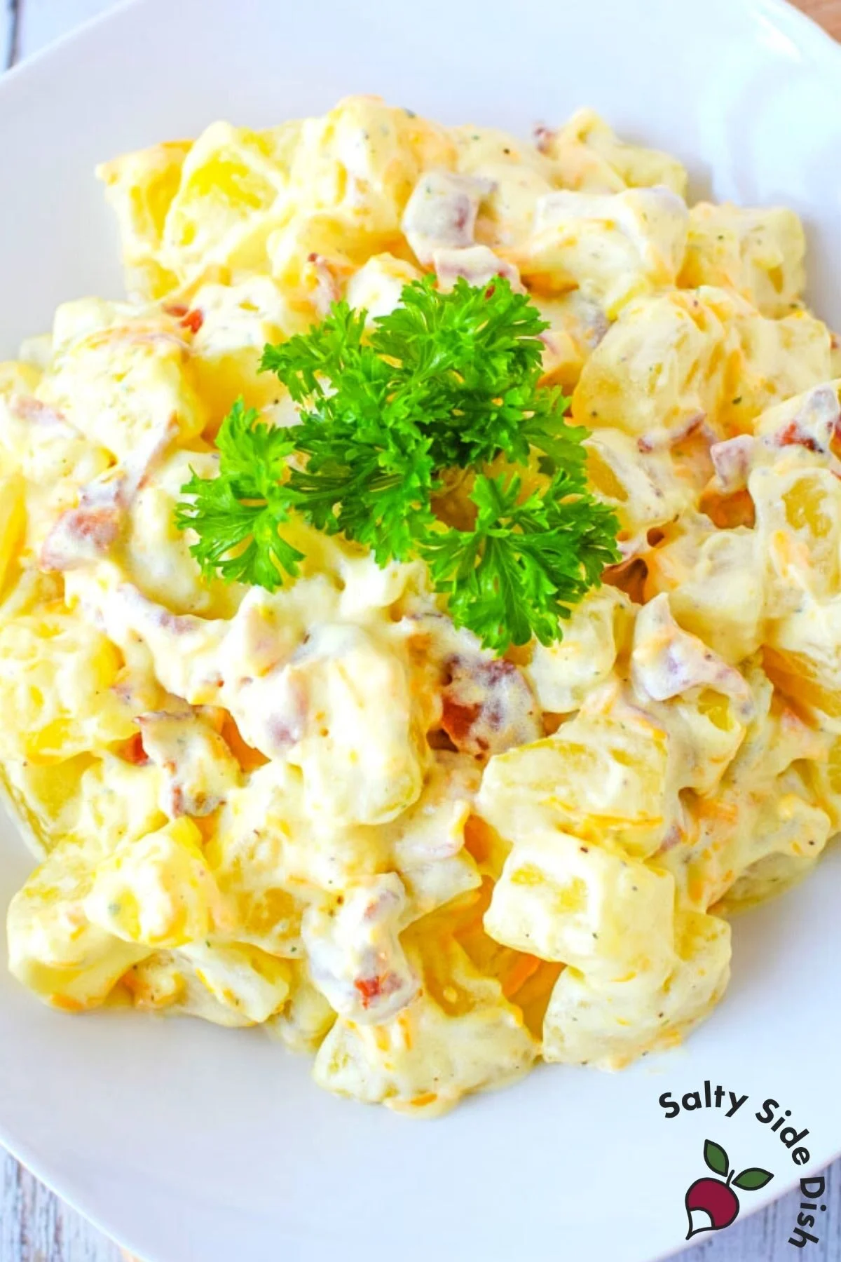 close up image of southern potato salad on a white plate.