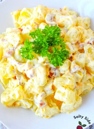 close up image of southern potato salad on a white plate.
