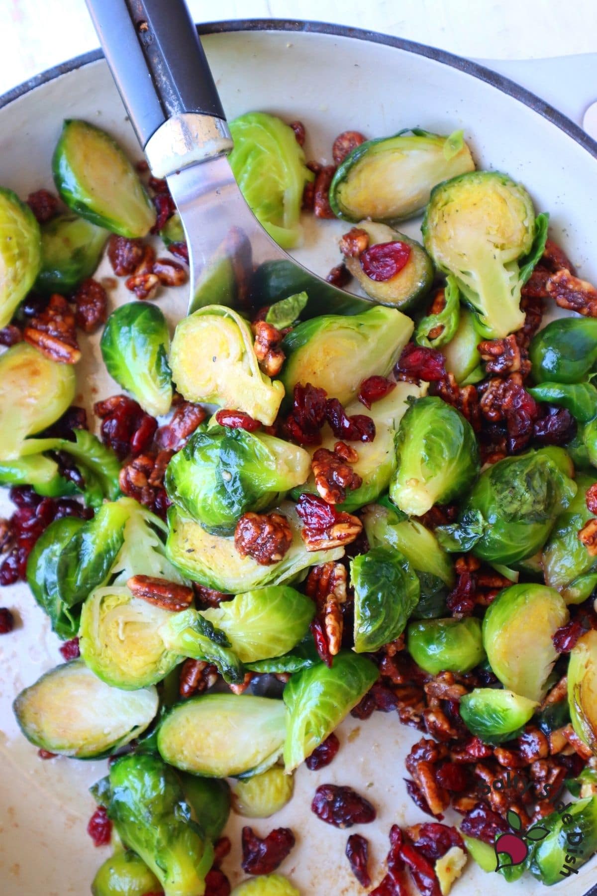 brussels sprouts being served with a spatula