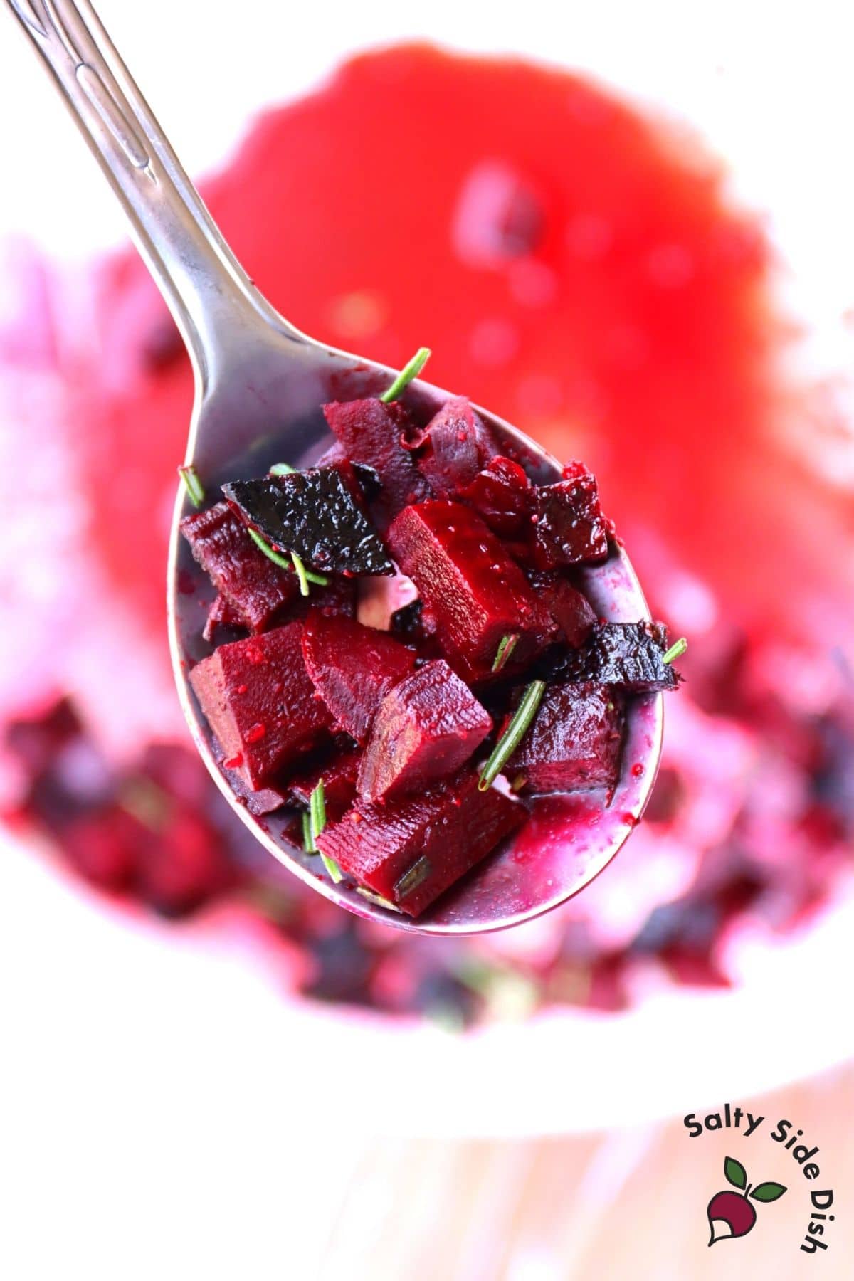 grilled diced beets in a spoon with fresh rosemary