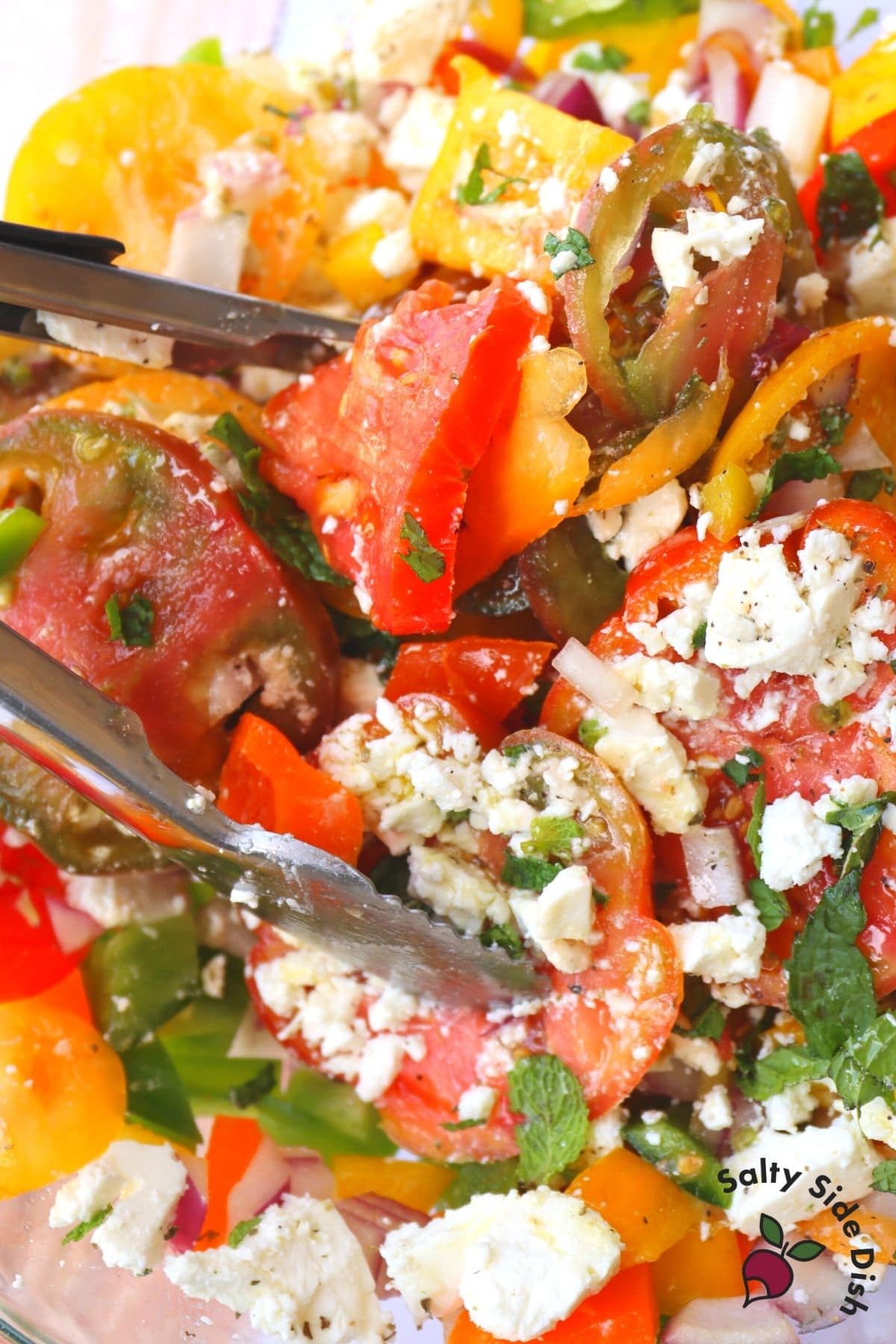 feta Greek tomato salad with tongs