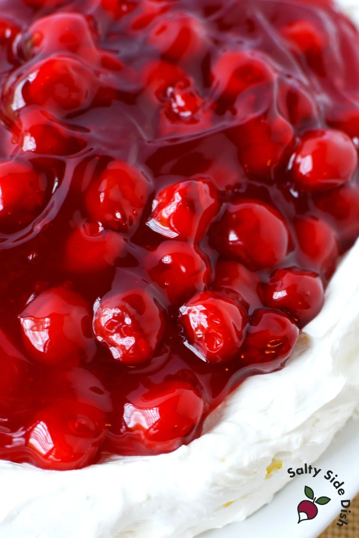 easy cherry cheesecake dip spread on a plate with cherry pie filling topping