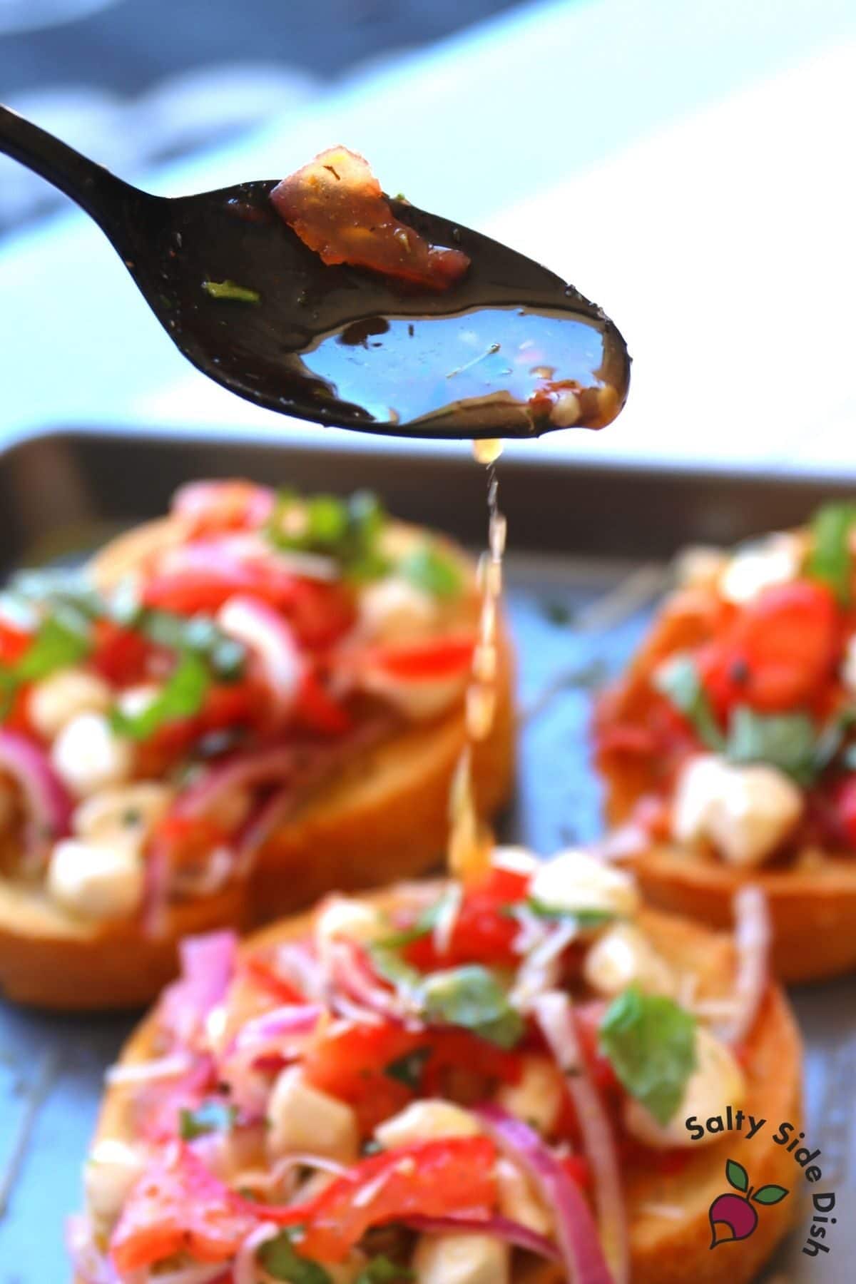drizzling oil on bruschetta
