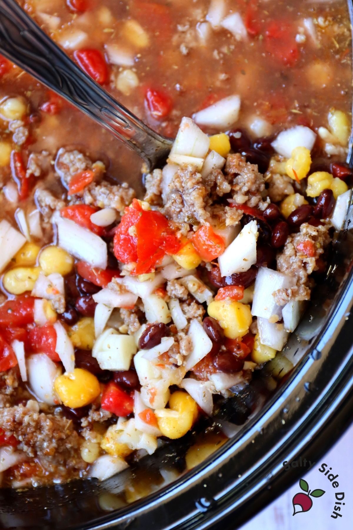 black bean soup in a ladle