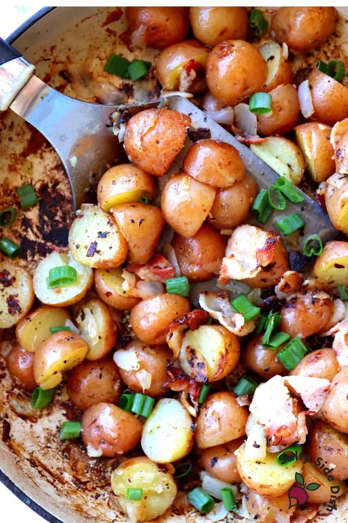 baby red potatoes braised in skillet with roasted onions and bacon