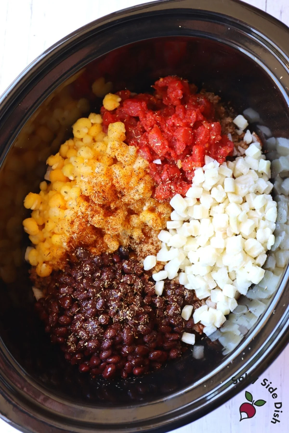 tomatoes, hominy, black beans and potatoes in a slow cooker