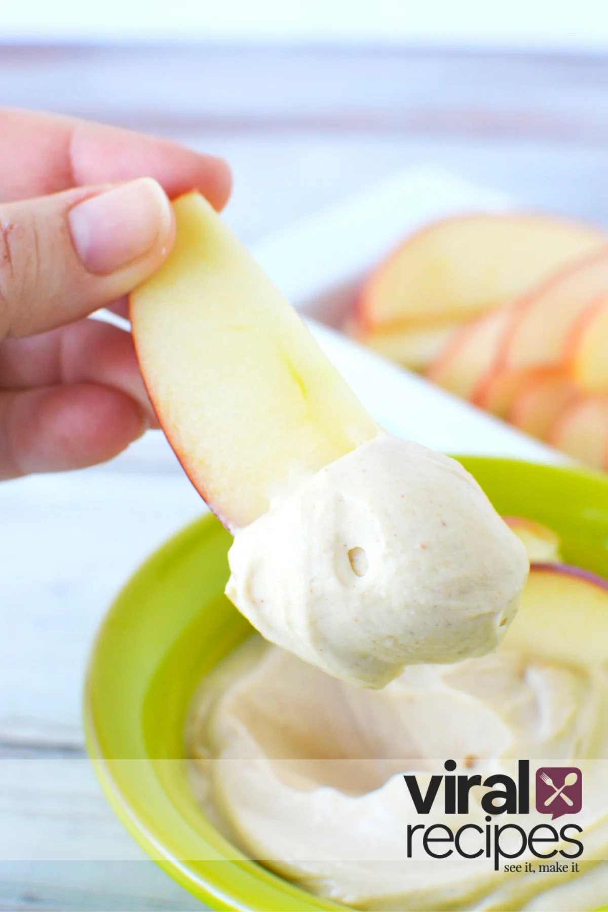 dipping apple in a peanut butter dip