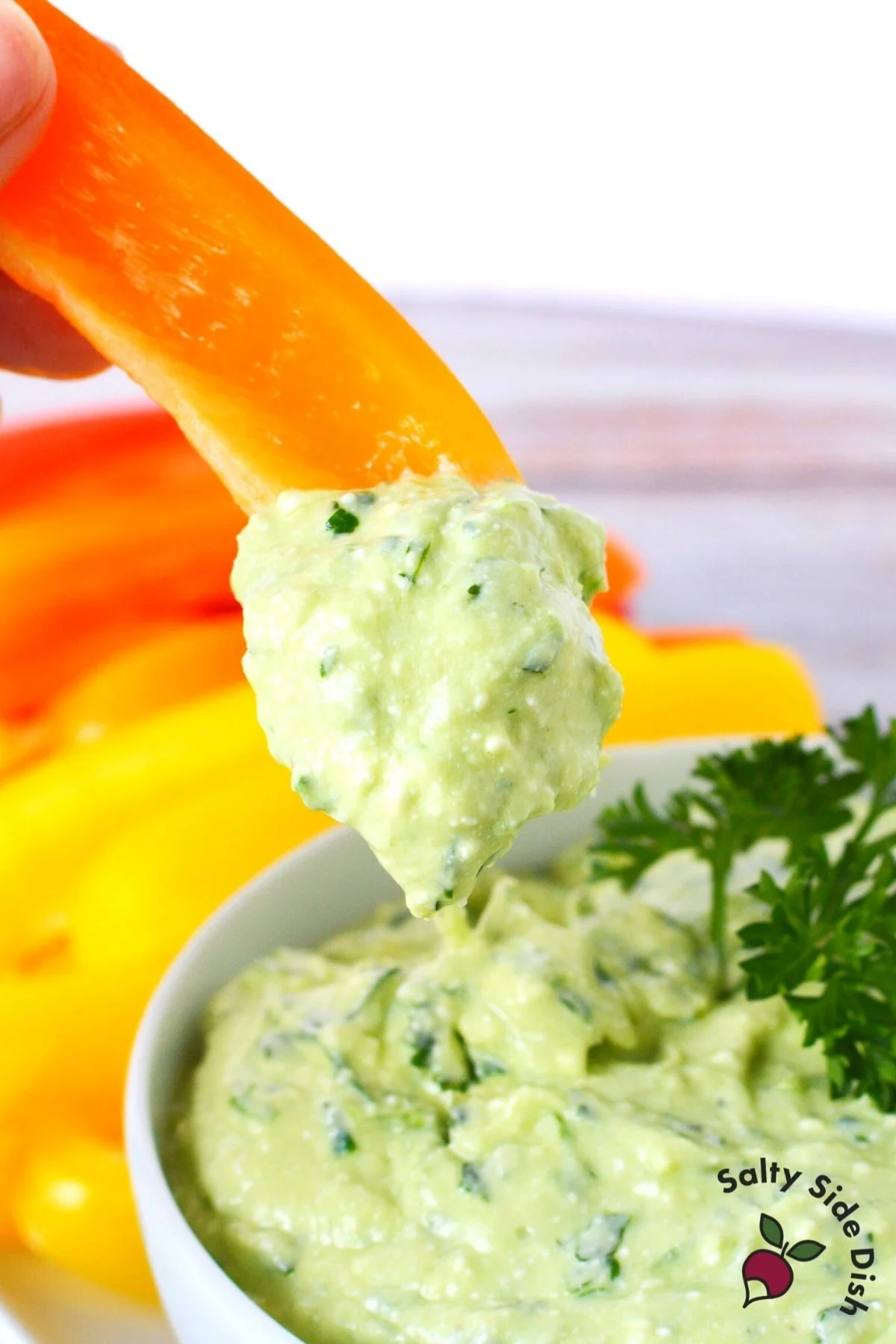 orange pepper in green goddess dip