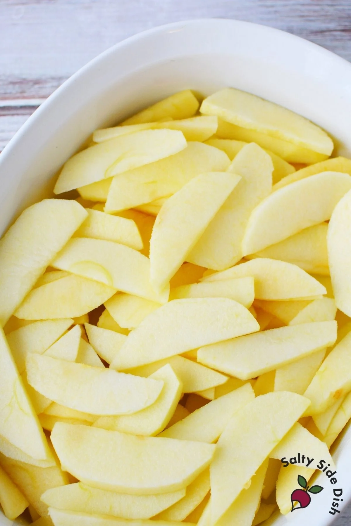 sliced apples in a casserole dish