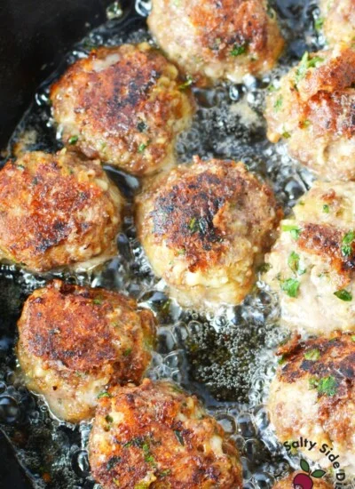 cast iron pan frying meatballs.
