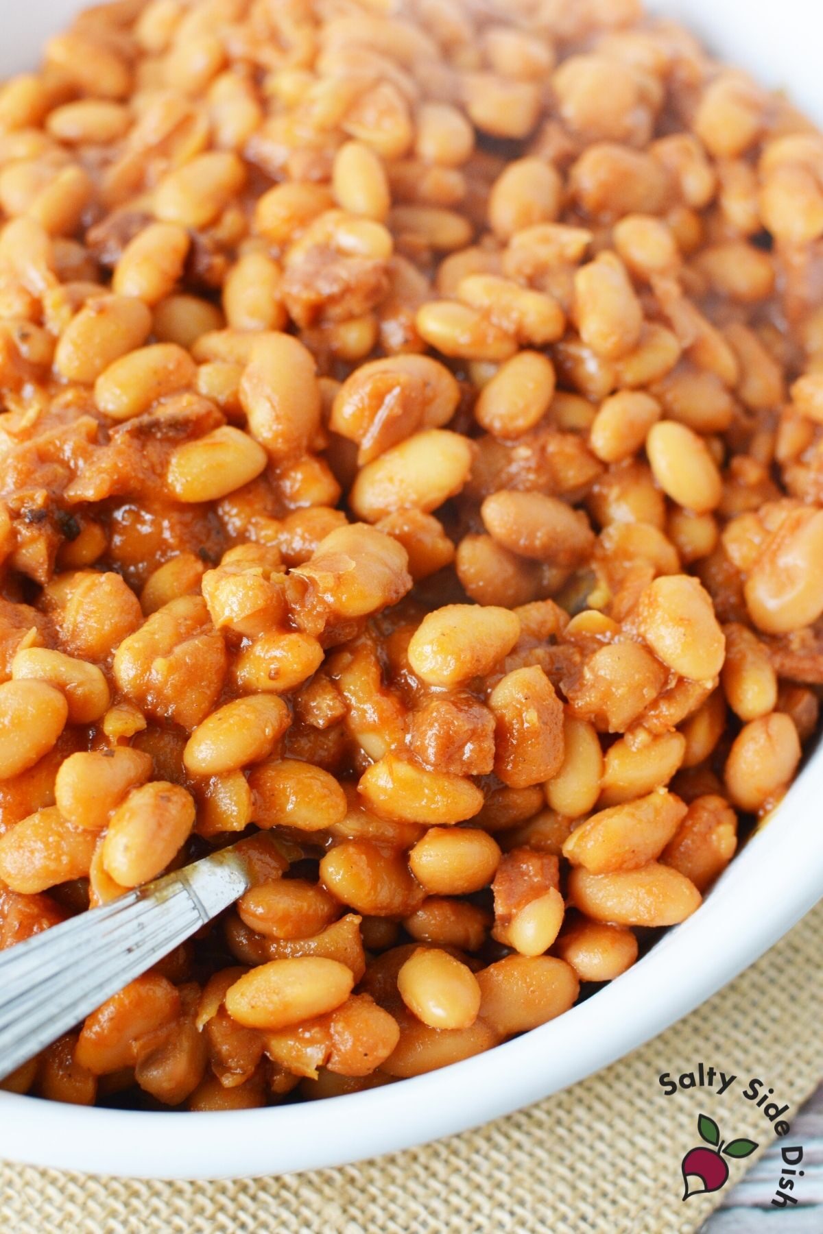 white bowl with completed canned beans and end of spoon sticking out