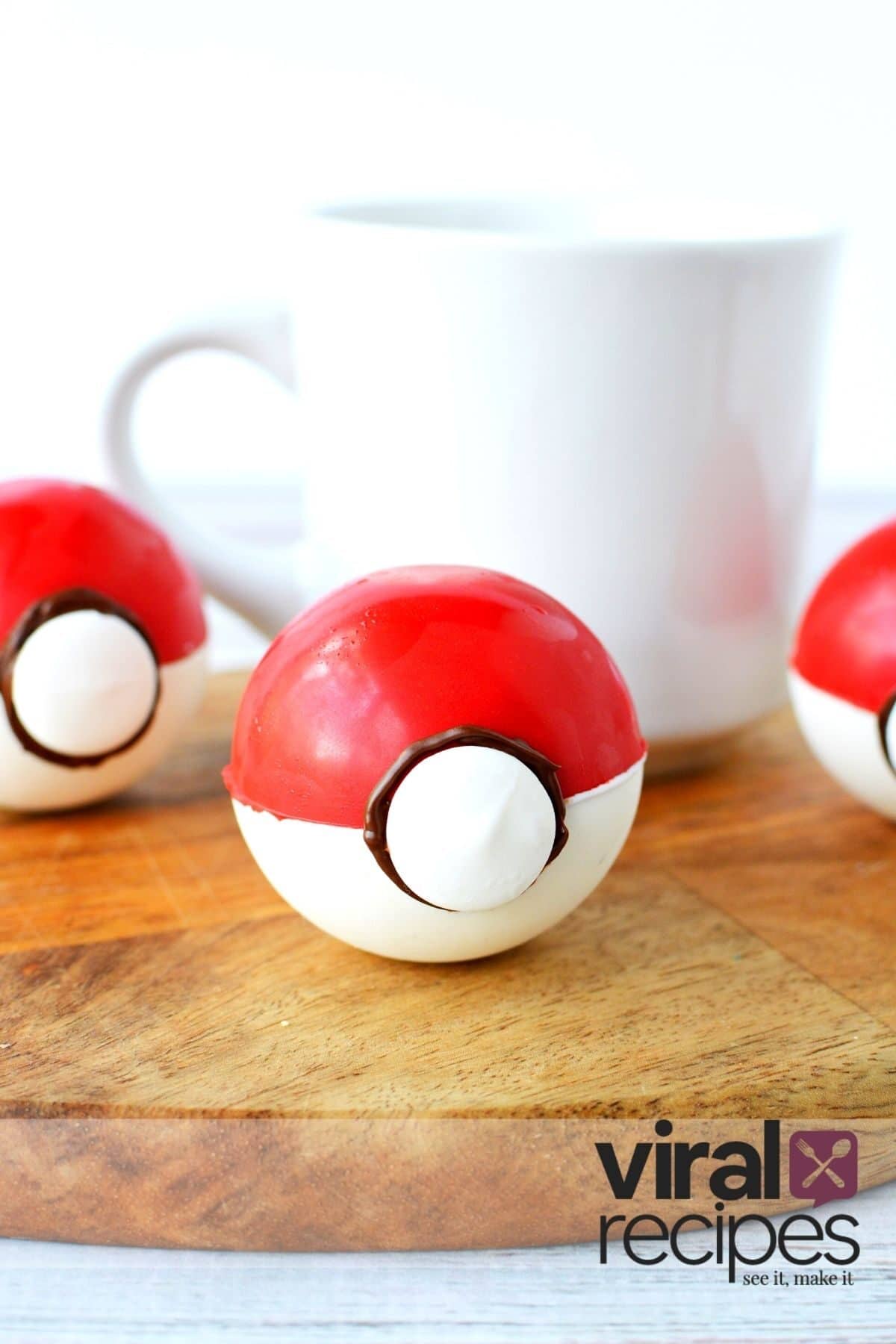 pokeball hot chocolate bombs by a mug