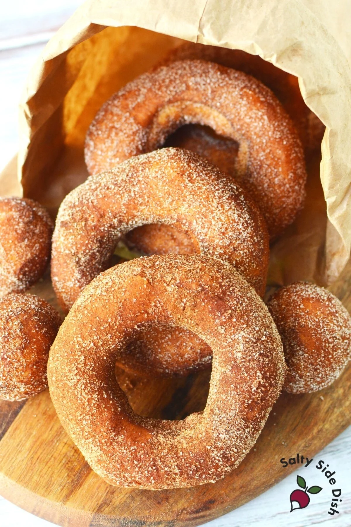 paper bag of donuts spilling out onto table