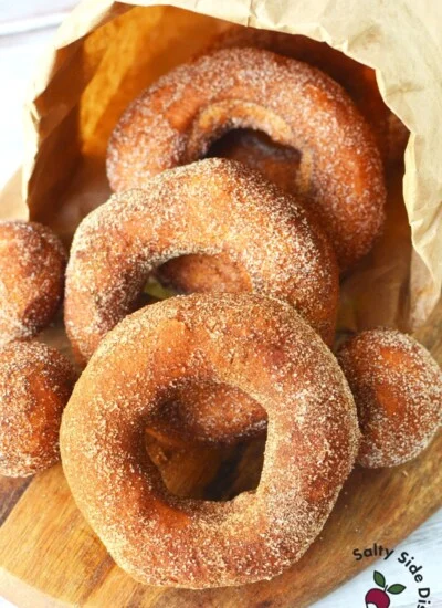 paper bag of donuts spilling out onto table