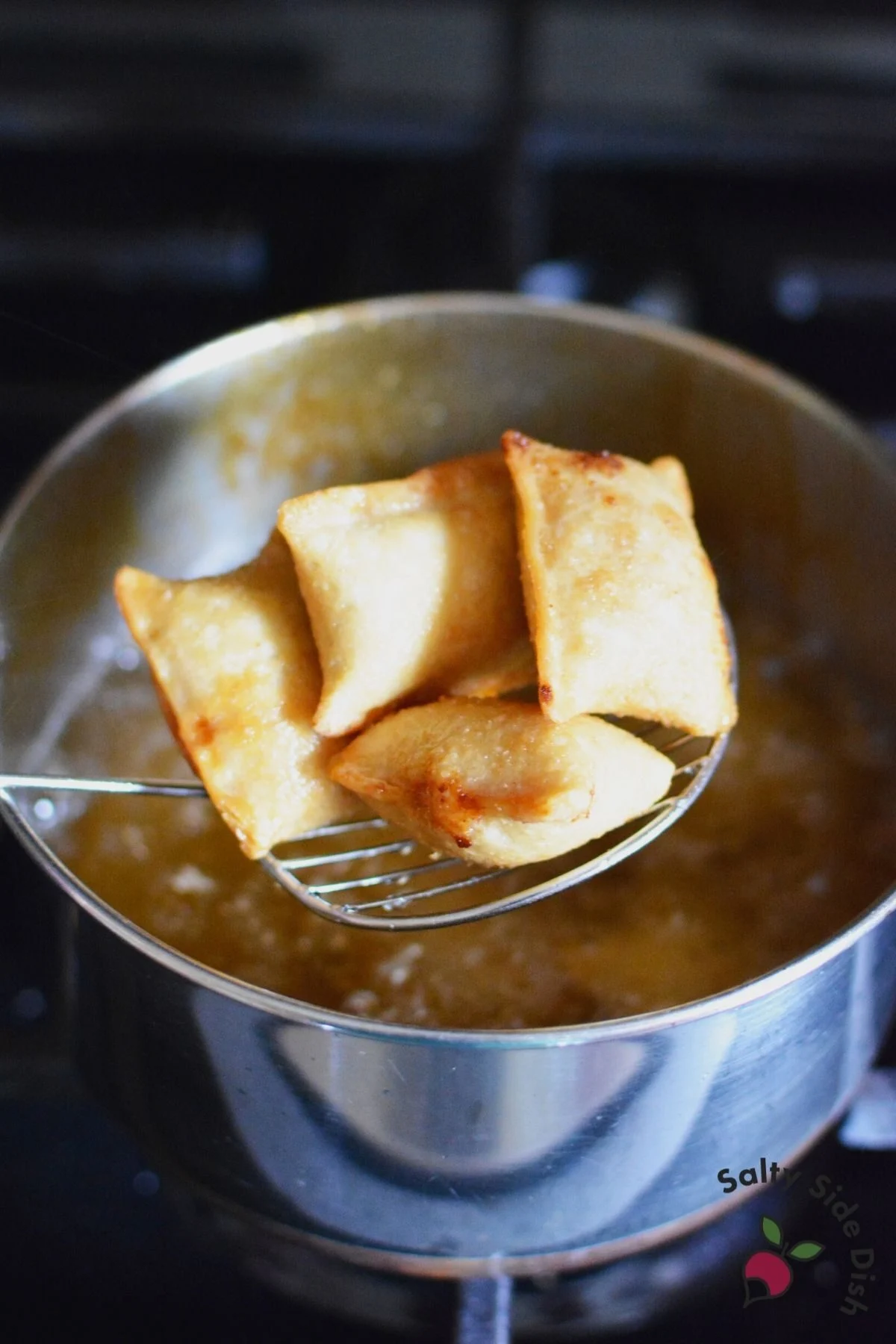 putting pizza rolls into oil