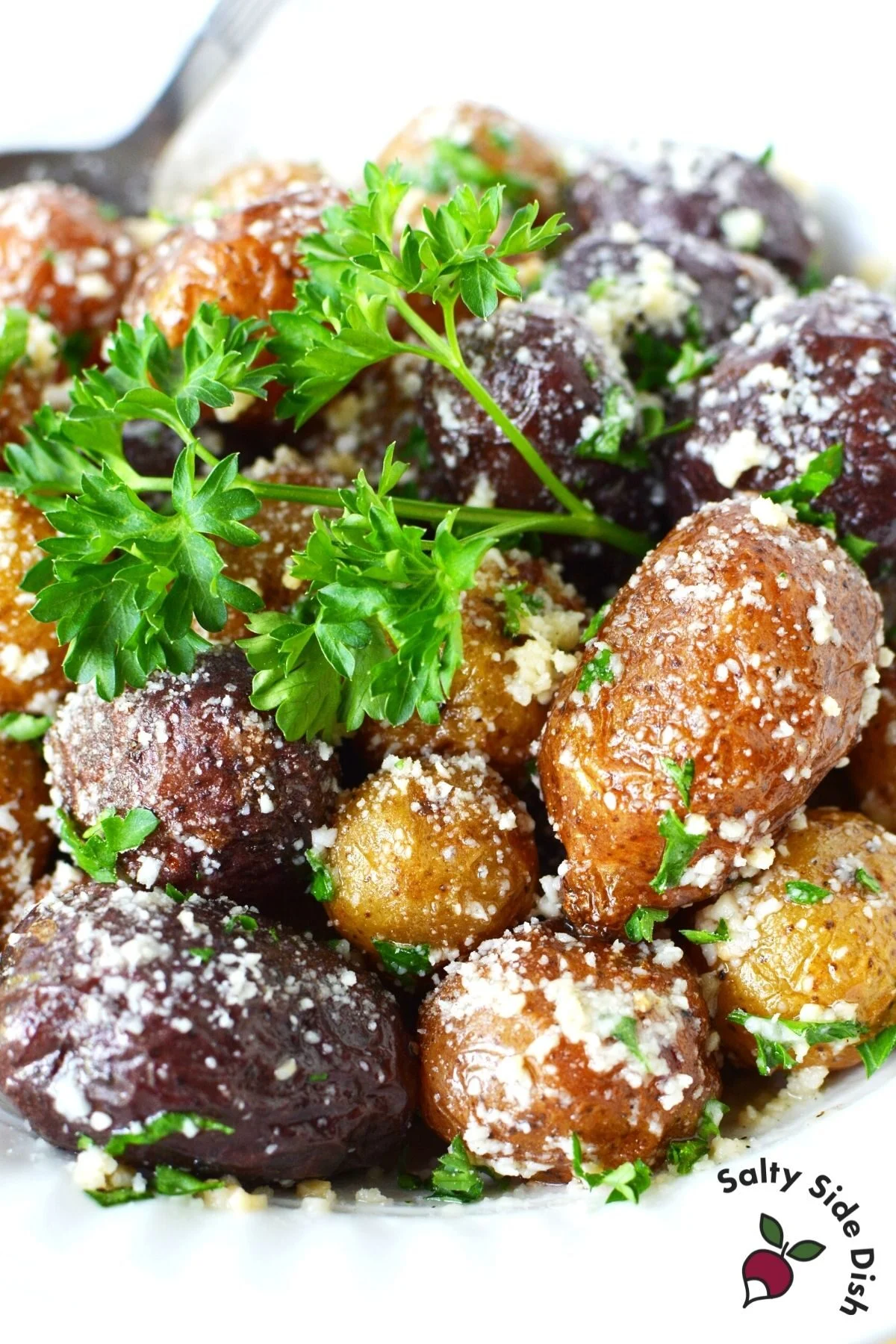 mini potatoes on a white plate with parsley