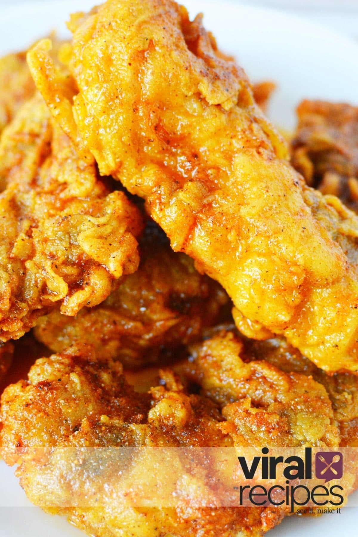 pile of hot chicken tenders on a plate.