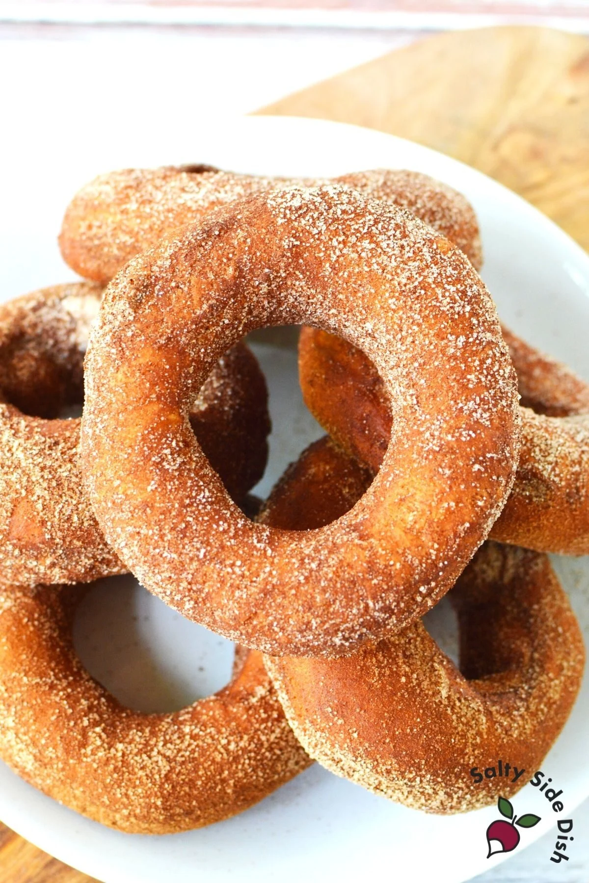 white plate piled high with cinnamon sugared donuts
