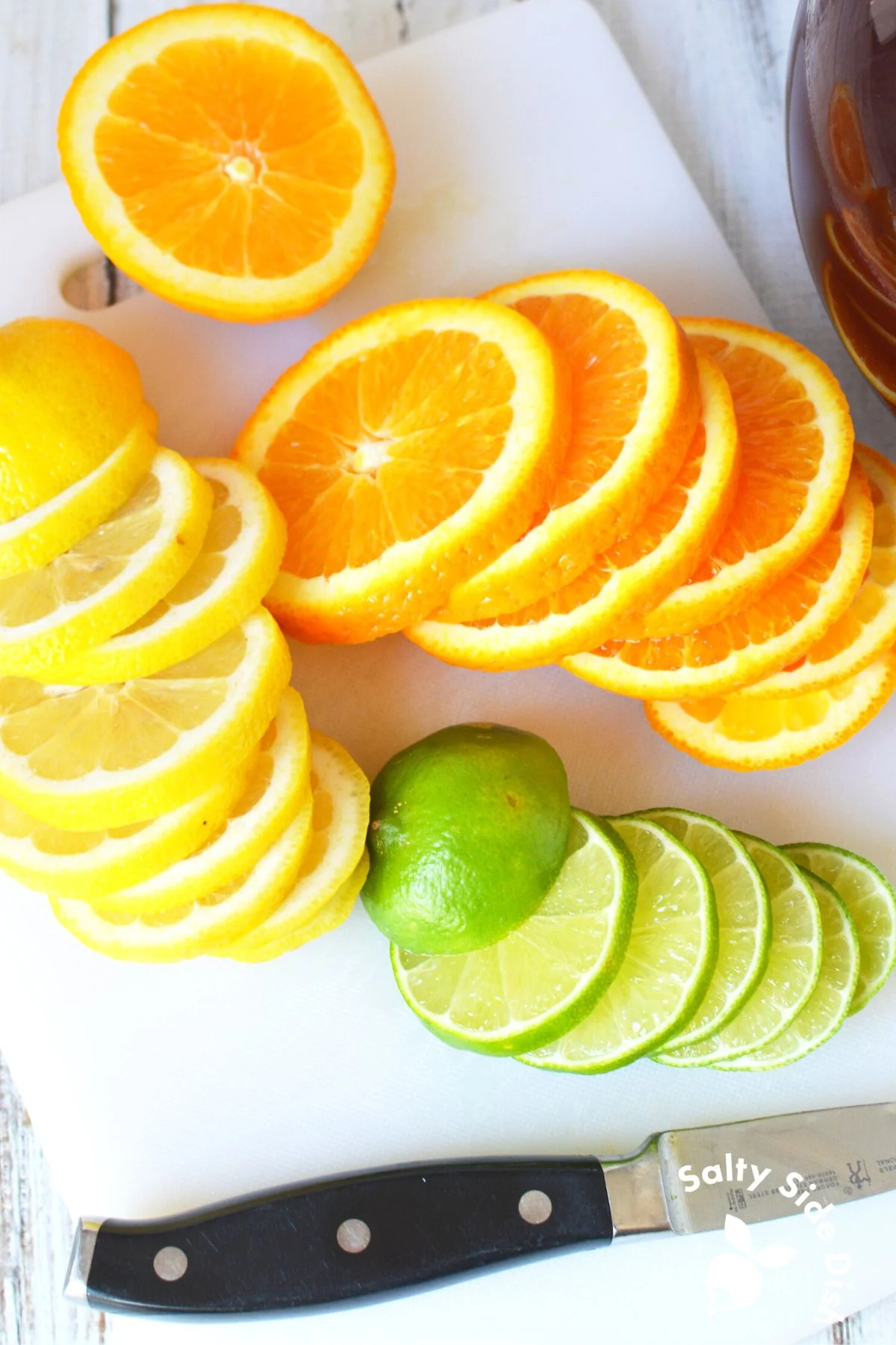 freshly sliced oranges, lemons, and limes on a cutting board.