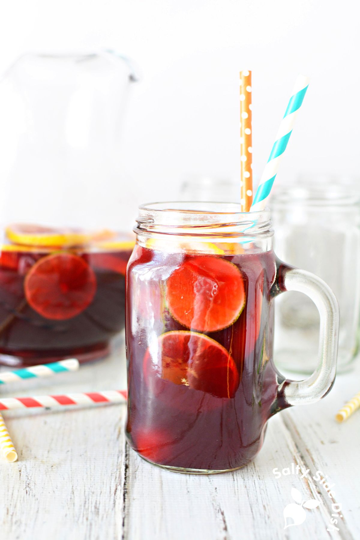 homemade sangria in a mason jar tea glass with straws.